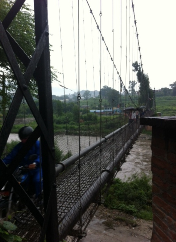 Footbridge to cross the river (shared with motorcycles, bikes, and pedestrians)